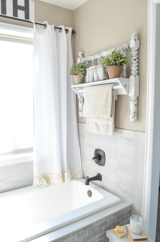DIY towel bar from Jenny Lind bed frame. Great farmhouse style bathroom decor idea!